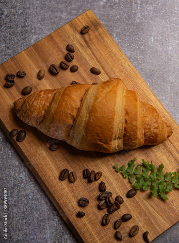 croissant with strawberry jam and coffee beans