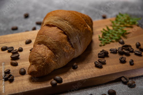 croissant with strawberry jam and coffee beans