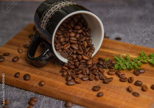 roasted coffee beans and a cup of coffee