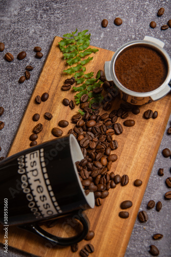 roasted coffee beans and a cup of coffee