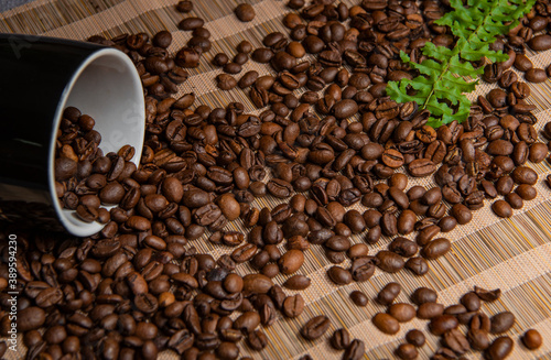 roasted coffee beans and a cup of coffee