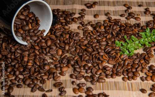 roasted coffee beans and a cup of coffee
