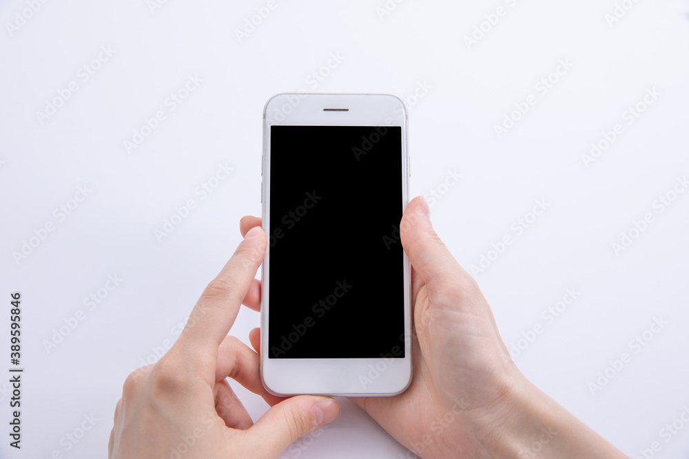female hands holding new modern black smartphone isolated on white background, close view . High quality photo female hands holding new modern black smartphone isolated on white background, close view . High quality photo