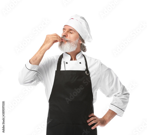 Mature male chef on white b...