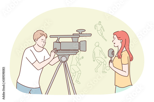 News, reportage, journalism, sport, interview, mass media concept. Team of woman reporter journalist man operator broadcasting soccer football match in stadium. Broadcast competition recording video.