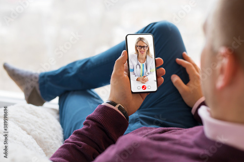Man talking with doctor on video call photo