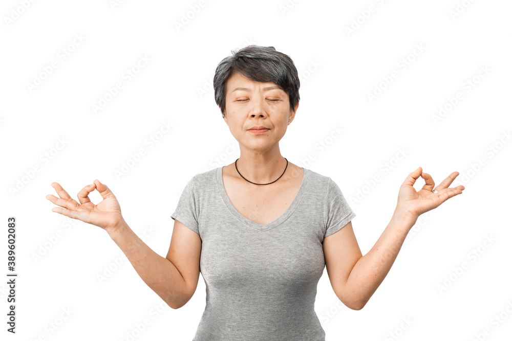 Middle age Asian woman wearing a grey T-shirt with grey hair isolated over white background relaxed and smiling with eyes closed doing meditation gesture with fingers. Yoga and meditation concept Middle age Asian woman wearing a grey T-shirt with grey hair isolated over white background relaxed and smiling with eyes closed doing meditation gesture with fingers. Yoga and meditation concept