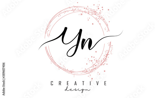 Handwritten YN Y N letter logo with sparkling circles with pink glitter.