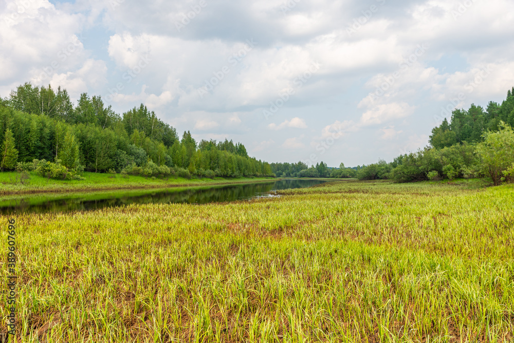Small river with slow flow, summer landscape Small river with slow flow, summer landscape