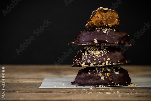 Chocolate covered greek Melomakarona with walnuts, stacked one on top of the other. photo