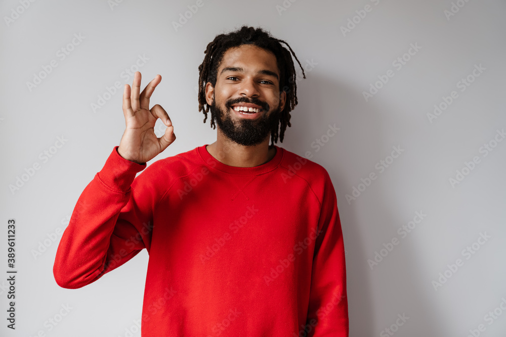 Joyful african american man smiling and showing ok sign at camera Joyful african american man smiling and showing ok sign at camera