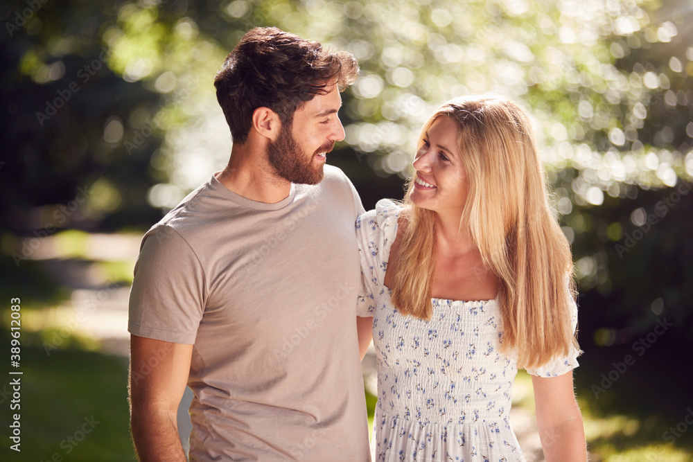 Loving Couple Walking Along Countryside Path In Summer Together Loving Couple Walking Along Countryside Path In Summer Together