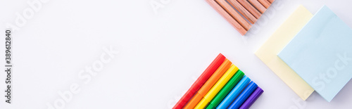 collection of colorful felt-tip pens with pencils and paper notes on light background, close view. High quality photo