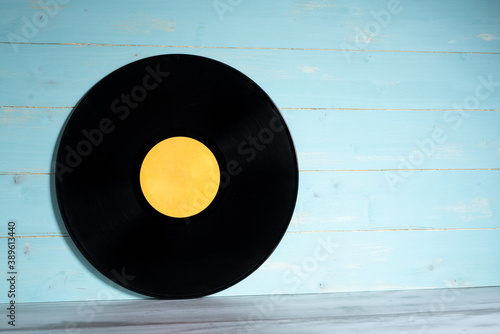 Vinyl record on wooden background,vintage style photo