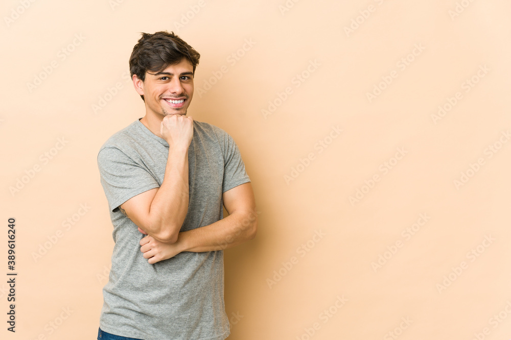 Young cool man smiling happy and confident, touching chin with hand. Young cool man smiling happy and confident, touching chin with hand.