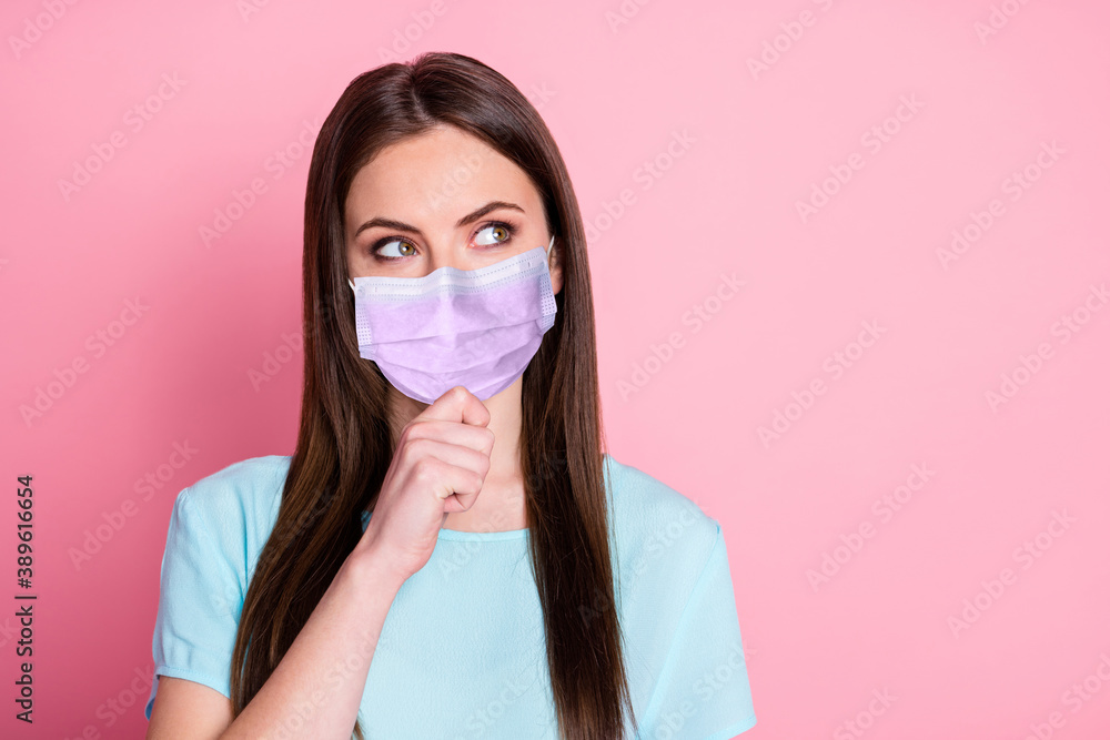 Photo of minded girl touch chin look copyspace wearing purple face mask isolated over pink color background Photo of minded girl touch chin look copyspace wearing purple face mask isolated over pink color background