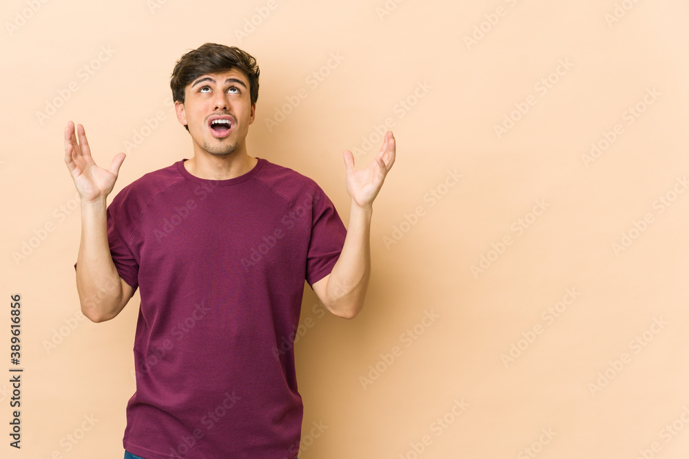 Young cool man screaming to the sky, looking up, frustrated. Young cool man screaming to the sky, looking up, frustrated.