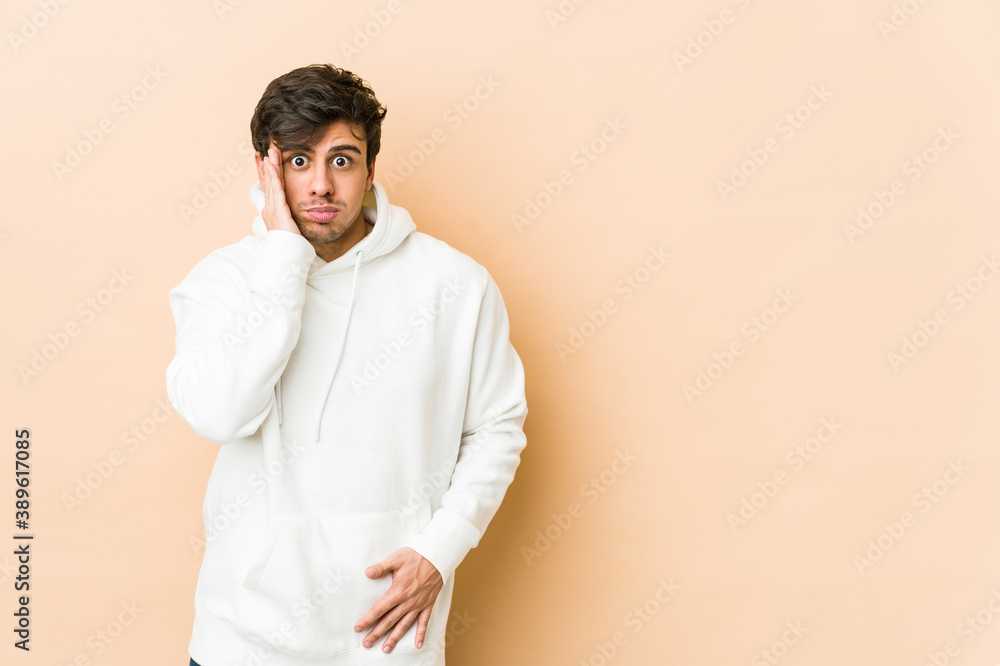 Young cool man blows cheeks, has tired expression. Facial expression concept. Young cool man blows cheeks, has tired expression. Facial expression concept.