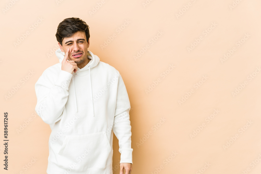 Young cool man crying, unhappy with something, agony and confusion concept. Young cool man crying, unhappy with something, agony and confusion concept.