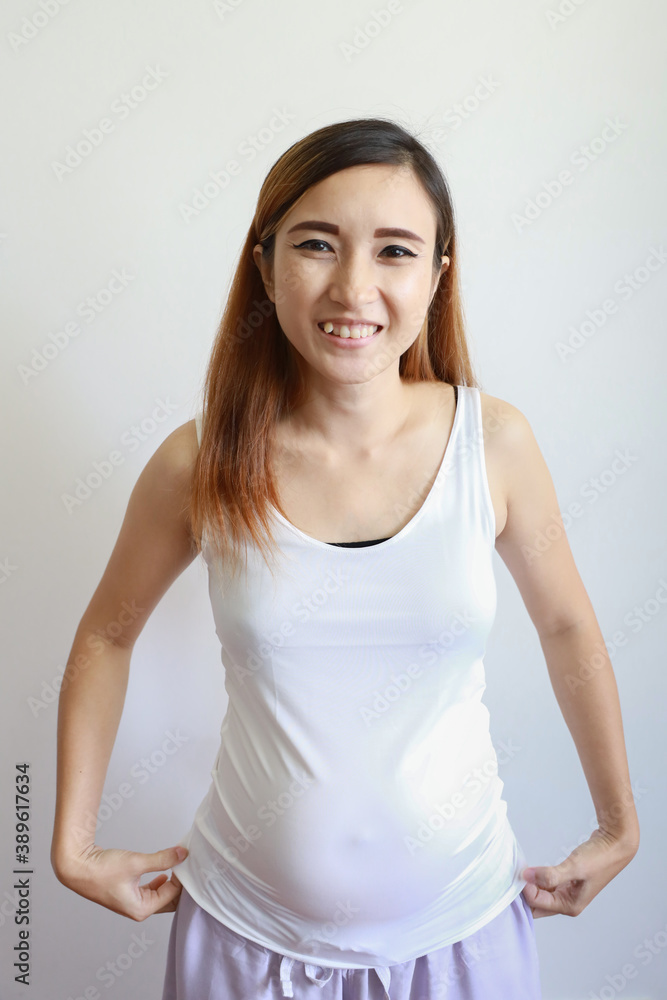 full length shot young asian pregnant belly in white dress with happy smiling face portrait and standing on white background full length shot young asian pregnant belly in white dress with happy smiling face portrait and standing on white background