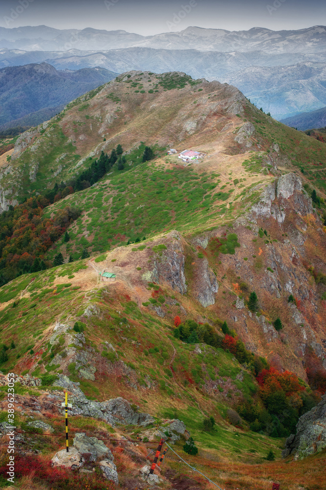 Fototapeta premium Beautiful autumn mountain view and landscapes from the path from Ribaritsa to Eho hut chalet and peaks Yumruka and Kavladan, Central Balkan, Teteven, Bulgaria