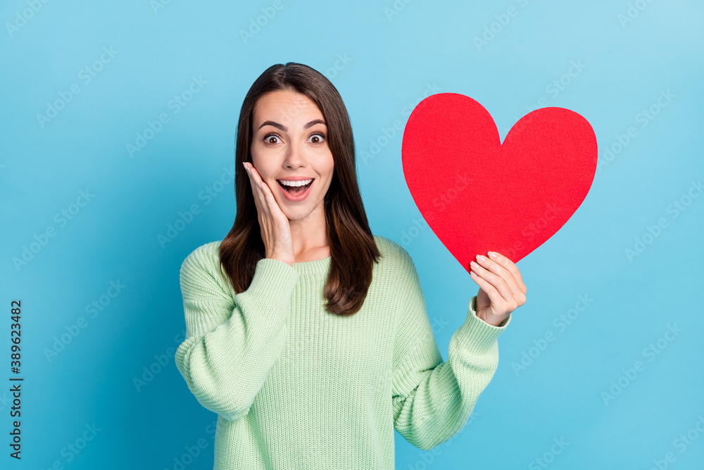 Photo portrait of amazed surprised girl showing red heart touching face  smiling looking up isolated on vibrant blue color background Stock Photo |  Adobe Stock