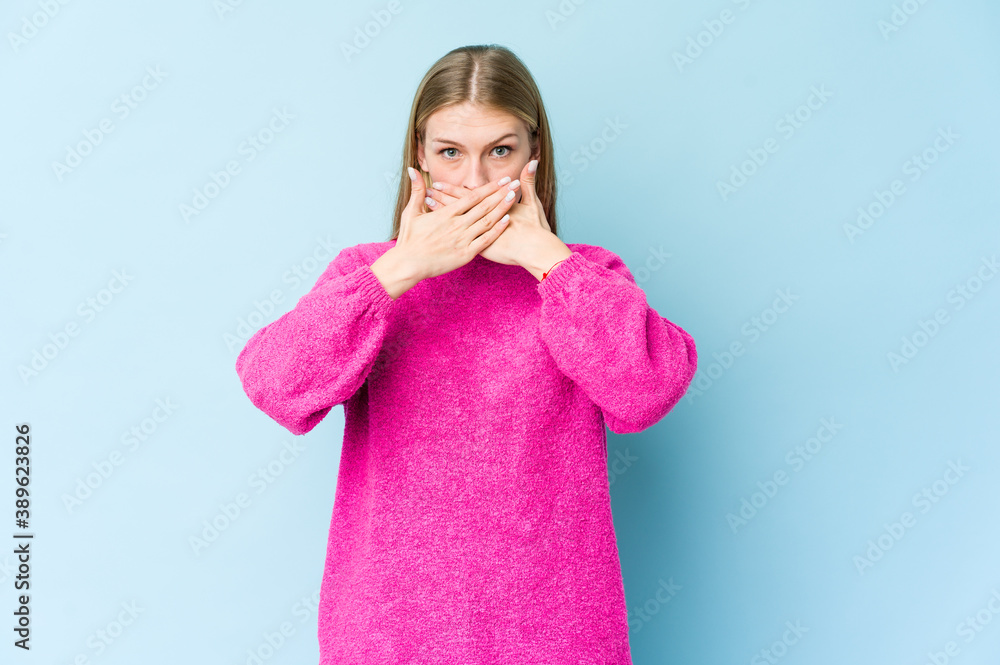 Young blonde woman isolated on blue background doing a denial gesture Young blonde woman isolated on blue background doing a denial gesture