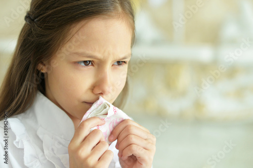 Portrait of sick little girl holding handkerchief