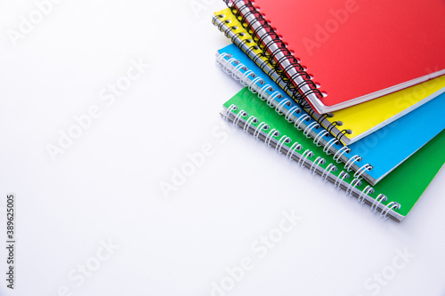 collection of colorful notebooks isolated on white background, close view. High quality photo