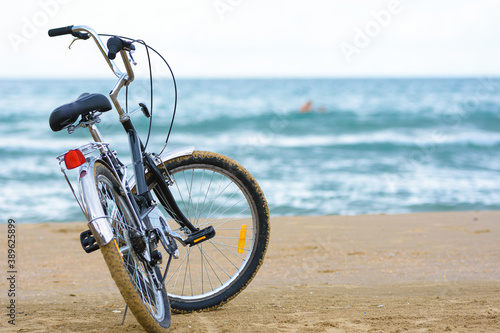 Close-up bike stands on the sea coast © madhourse
