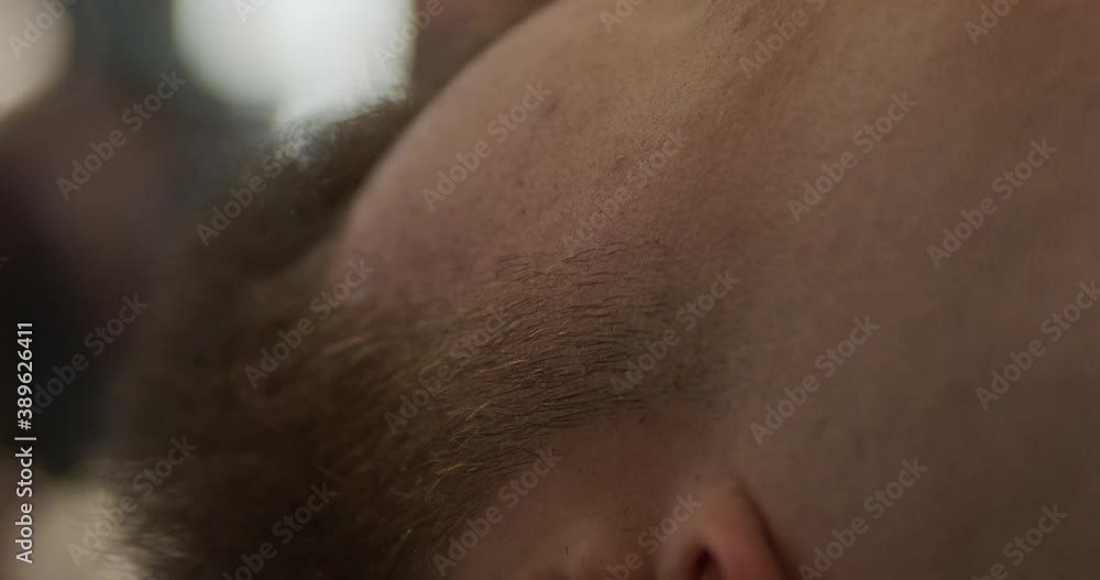 professional barber cuts the sideburns for his client professional barber cuts the sideburns for his client