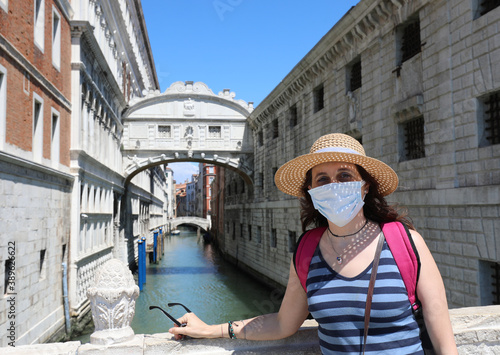 young woman with mask and straw hat while visiting Venice and br © ChiccoDodiFC