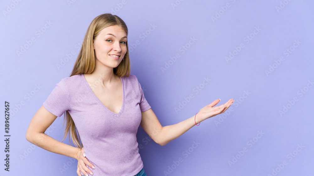Young blonde woman isolated on purple background showing a welcome expression. Young blonde woman isolated on purple background showing a welcome expression.