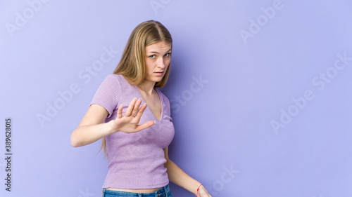 Fotografie Young blonde woman isolated on purple background being shocked due to an imminen