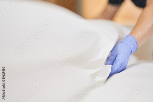 Female hands adjusting the pillow in hotel room