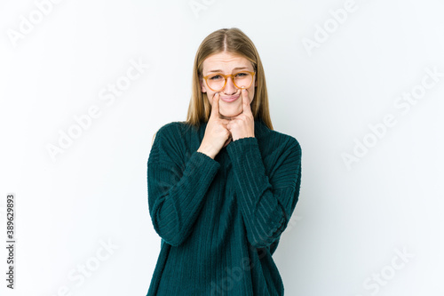 Young blonde woman isolated on white background doubting between two options.