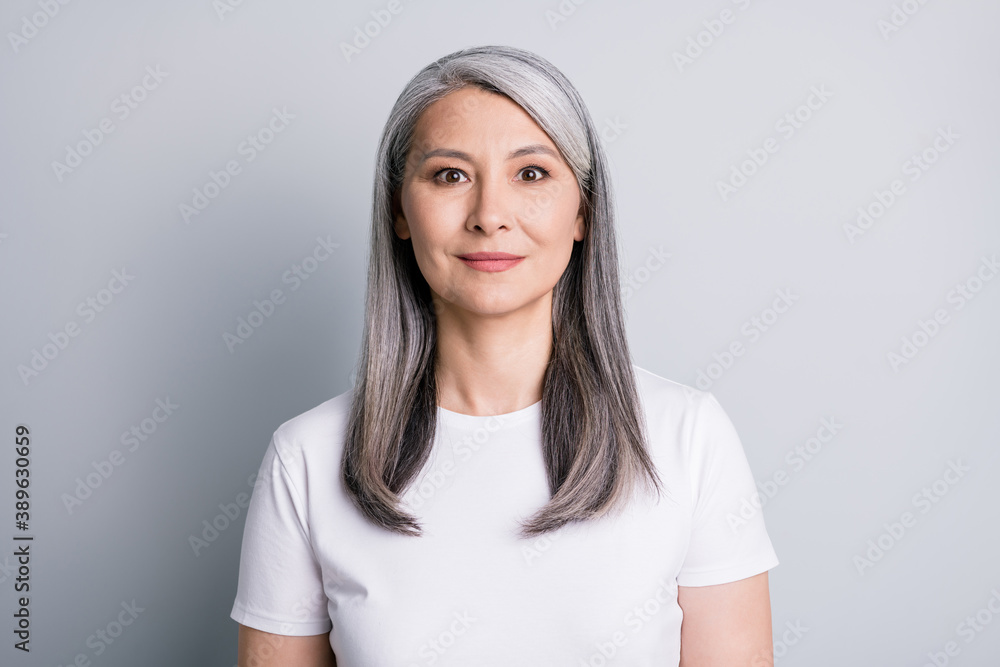 Photo of calm pensioner old lady look camera smile wear white t-shirt isolated grey color background Photo of calm pensioner old lady look camera smile wear white t-shirt isolated grey color background