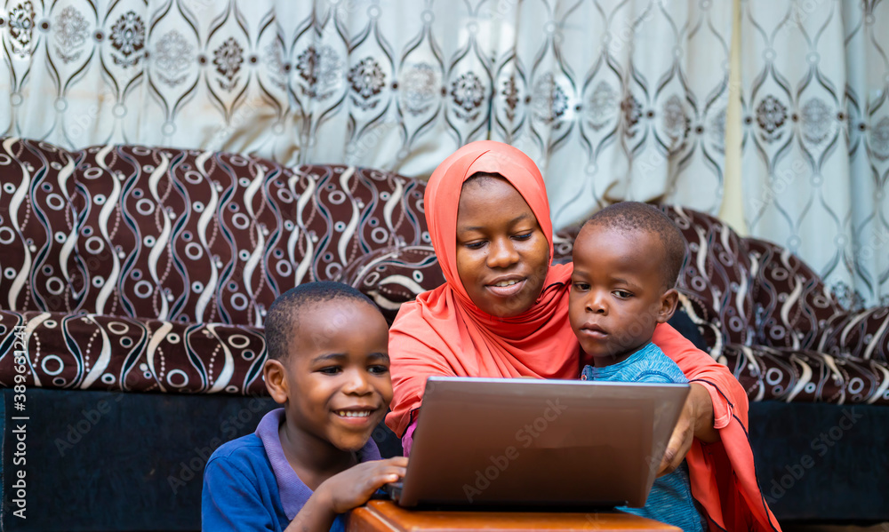 black african family doing home schooling with digital laptop during quarantine period - obrazy, fototapety, plakaty 