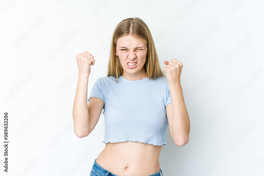 Young blonde woman isolated on white background showing fist to camera, aggressive facial expression. Young blonde woman isolated on white background showing fist to camera, aggressive facial expression.