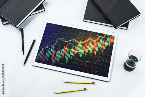 Modern digital tablet monitor with abstract creative financial chart, research and strategy concept. Top view. 3D Rendering
