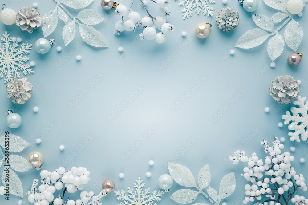Christmas frame with festive decorations, snowflakes, baubles on pastel background. Flat lay. Top view, copy space. Christmas frame with festive decorations, snowflakes, baubles on pastel background. Flat lay. Top view, copy space.