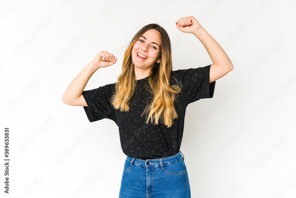 Young caucasian woman isolated on white background celebrating a special day, jumps and raise arms with energy. Young caucasian woman isolated on white background celebrating a special day, jumps and raise arms with energy.