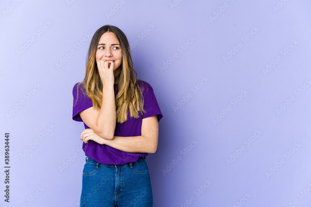Young caucasian woman isolated on purple background biting fingernails, nervous and very anxious. Young caucasian woman isolated on purple background biting fingernails, nervous and very anxious.