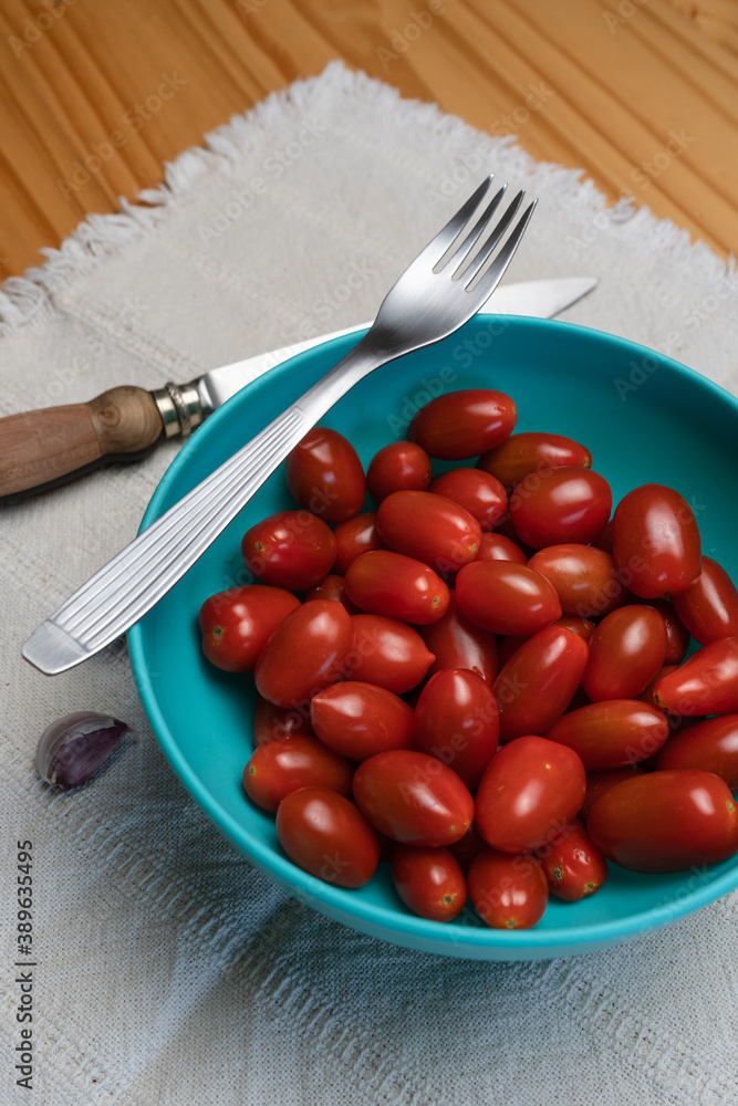 bowl full of delicious ready-to-eat cherry tomatoes. Vertical shot. bowl full of delicious ready-to-eat cherry tomatoes. Vertical shot.