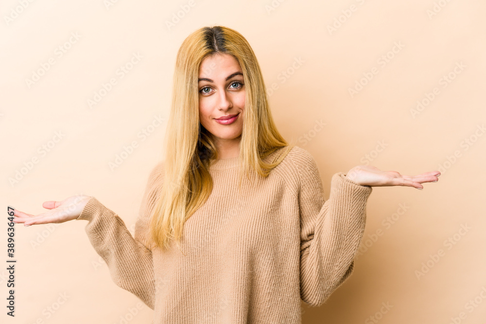 Young blonde caucasian woman showing a welcome expression. Young blonde caucasian woman showing a welcome expression.