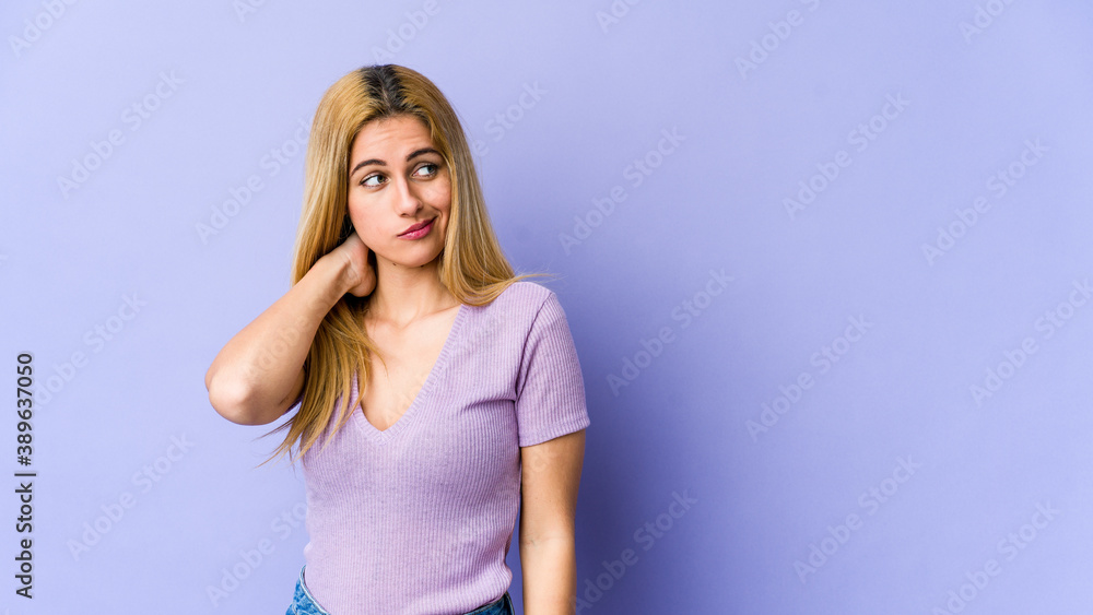 Young blonde caucasian woman touching back of head, thinking and making a choice. Young blonde caucasian woman touching back of head, thinking and making a choice.