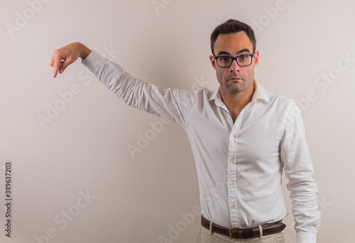 man with glasses and white shirt showing something that could be spectacular.