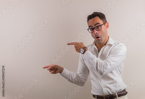 man with glasses and white shirt showing something that could be spectacular.