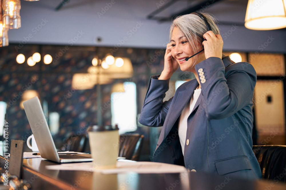 Charming businesswoman using laptop for online communication Charming businesswoman using laptop for online communication