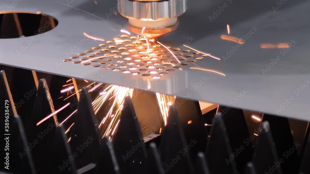 Slow motion: automatic cnc laser cutting machine working with sheet metal with sparks at factory, plant. Metalworking, machining, industrial, equipment, technology, manufacturing concept